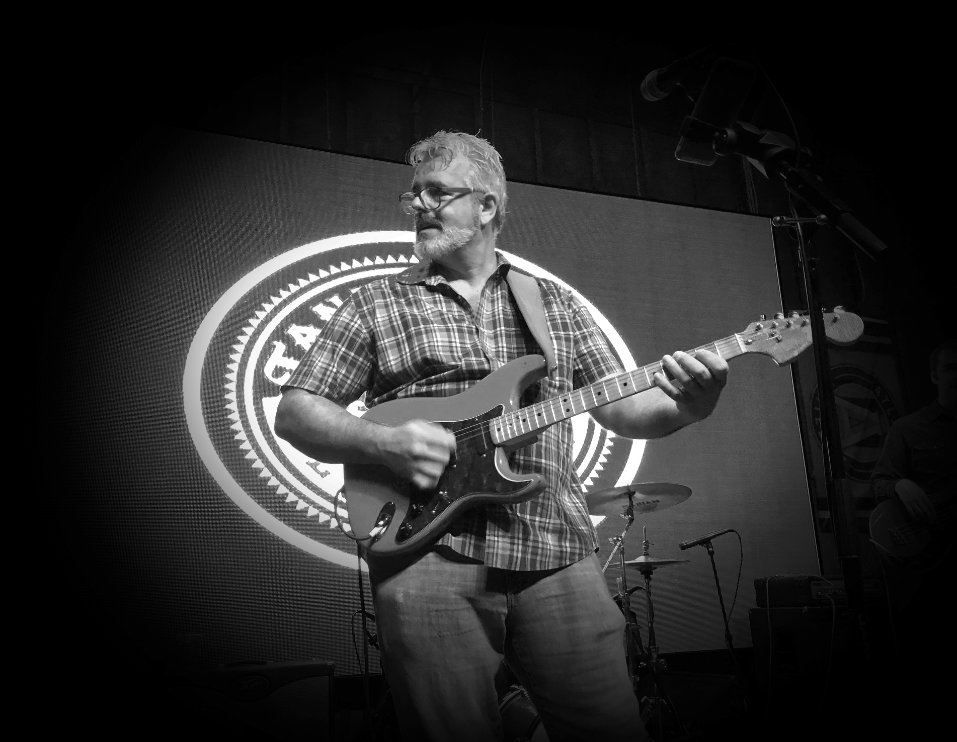 Ivan Duke in Stage holding a guitar